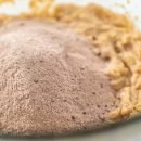 Chocolate graham crackers Mixing ingredients in a glass mixing bowl to bake chocolate graham crackers.